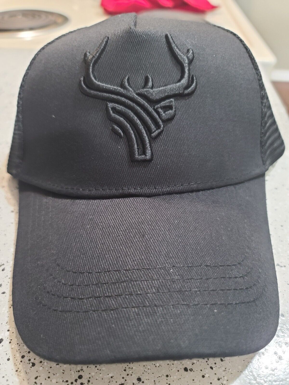 ANTLERS EMBROIDERED TRUCKER MESH HAT.