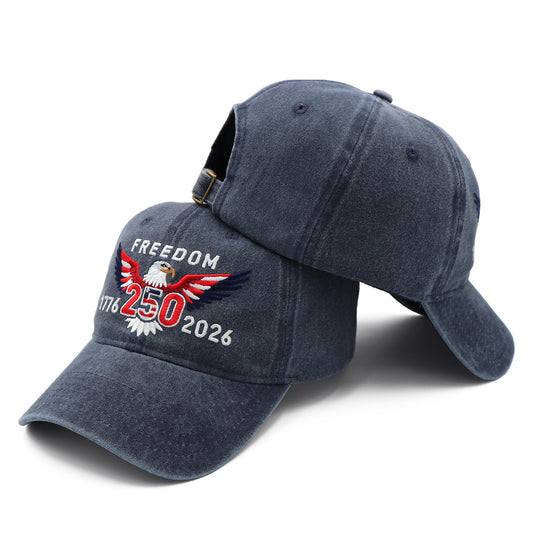 Blue denim cap with eagle emblem and 'Freedom 1776-2026' text on a white background